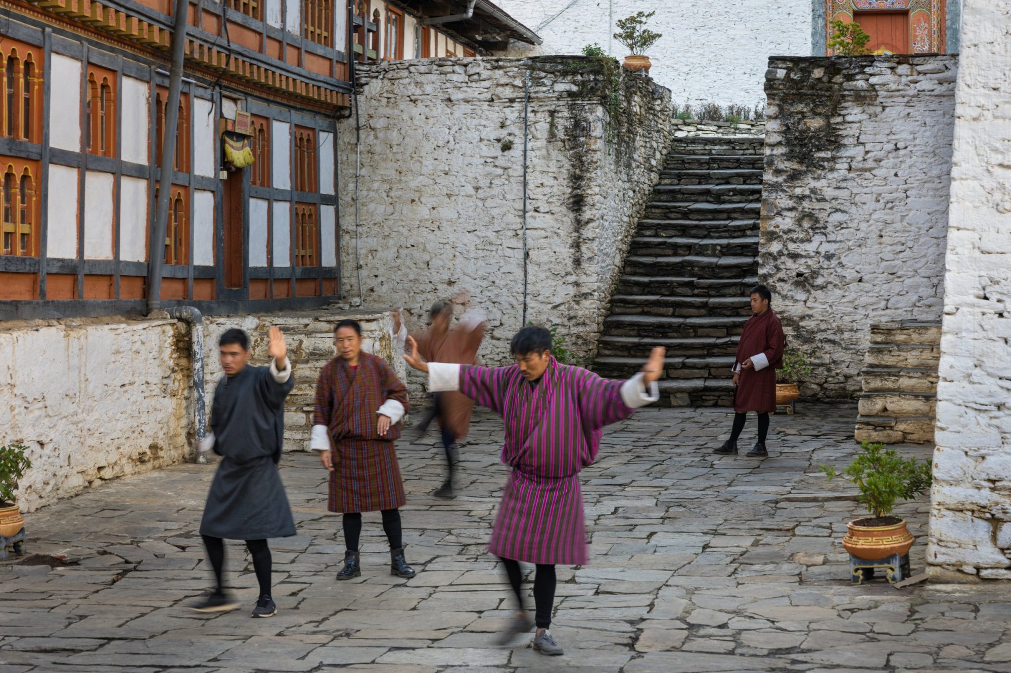 Dancers rehearsing in a monastery courtyard in Bumthang